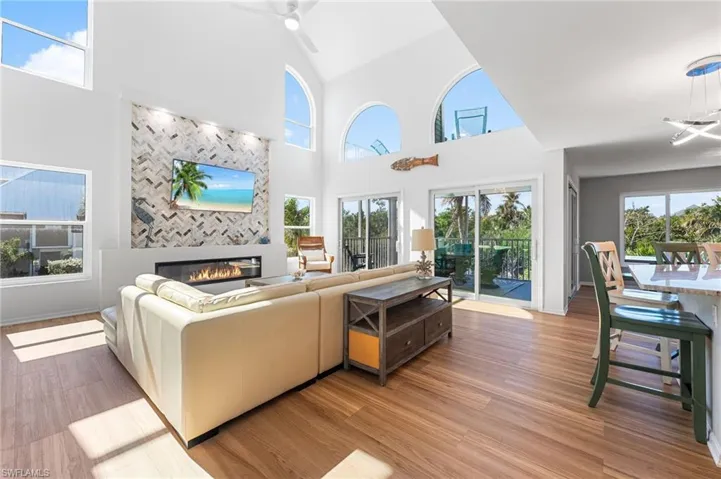 An open-concept living space filled with natural light and framed by serene water views.