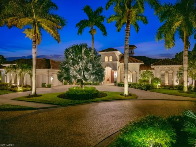 The property at night highlighting landscape lighting