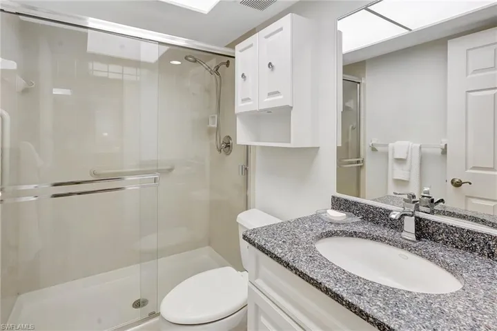 Full bath featuring a stall shower and vanity