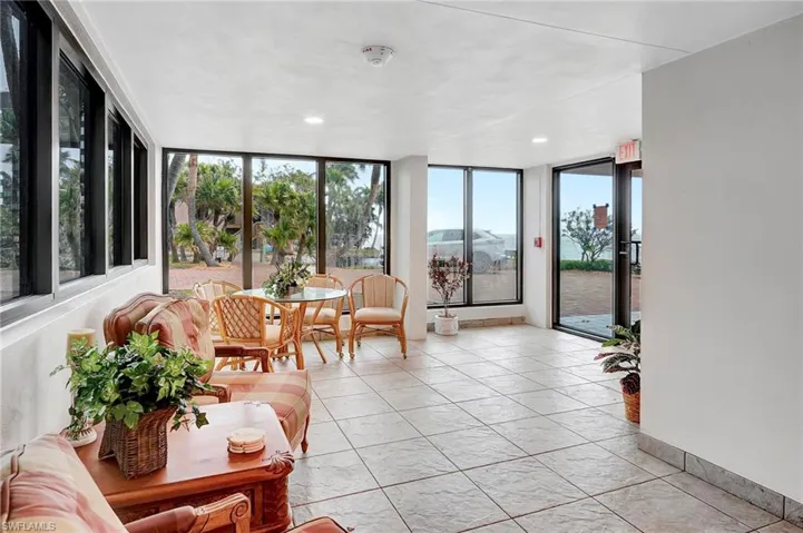 Sunroom / solarium featuring expansive windows, recessed lighting, and tile patterned floors