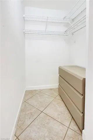 Walk in closet featuring light tile patterned flooring