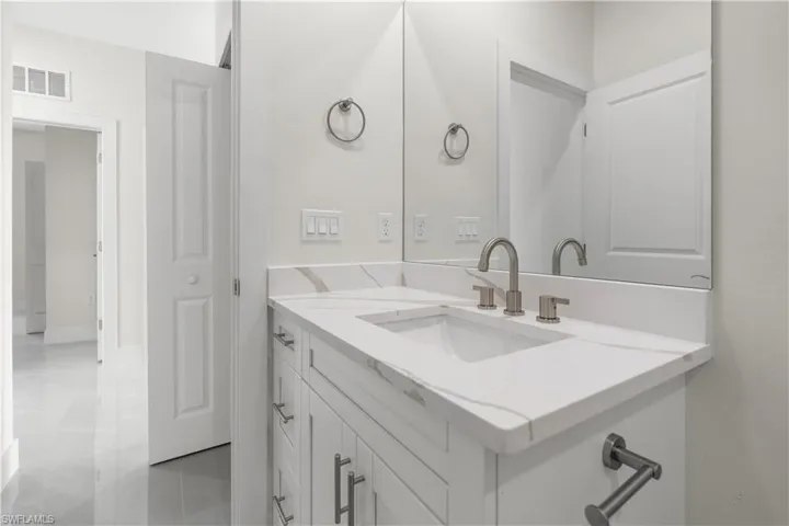 Bathroom with vanity and light tile patterned flooring