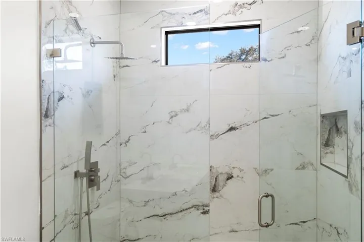 Bathroom featuring a marble finish shower