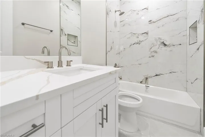 Bathroom featuring vanity and bathing tub / shower combination