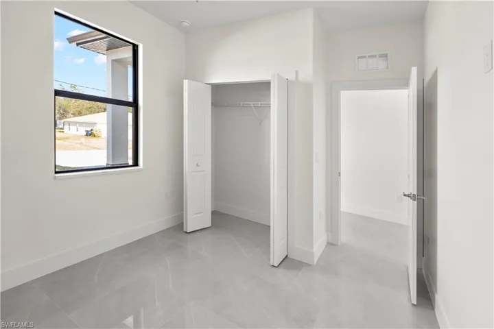 Unfurnished bedroom featuring baseboards and a closet