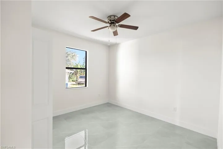 Empty room with baseboards and ceiling fan