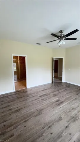 Spare room featuring light wood-style flooring, a textured ceiling, and ceiling fan