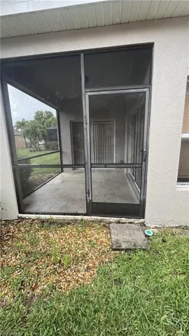 Property entrance with stucco siding