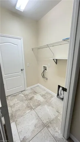 Laundry room with baseboards and washer hookup