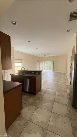 Kitchen with dark countertops, open floor plan, healthy amount of natural light, and recessed lighting