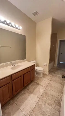 Bathroom featuring vanity and a textured ceiling