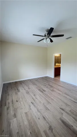 Unfurnished room featuring light wood-type flooring and a ceiling fan