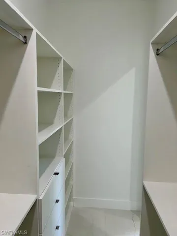 Spacious closet with tile patterned floors