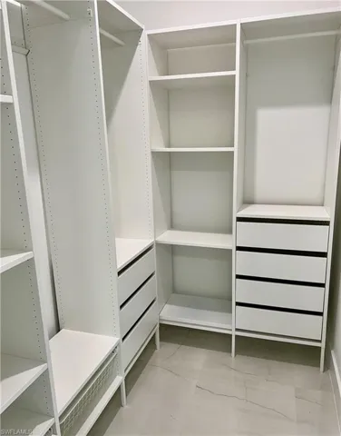 Spacious closet featuring light tile patterned floors