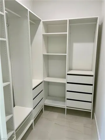 Walk in closet featuring light tile patterned floors