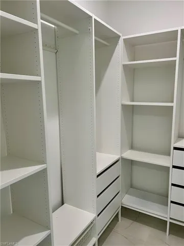 Spacious closet featuring light tile patterned flooring