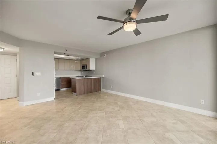 Unfurnished living room featuring ceiling fan