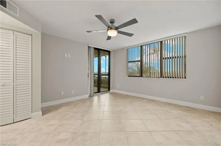 Unfurnished room with light tile patterned flooring and ceiling fan