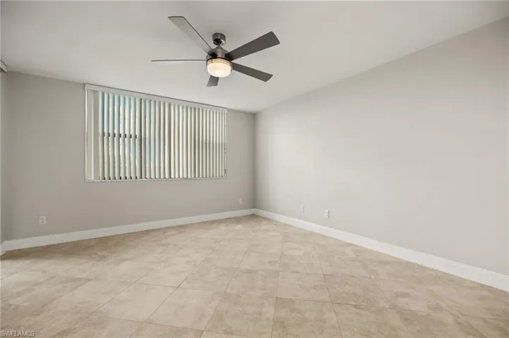 Unfurnished room featuring ceiling fan and light tile patterned floors