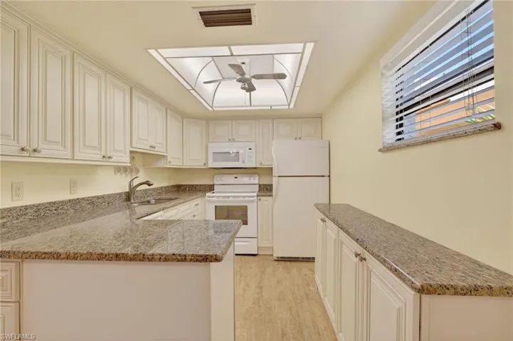 Updated kitchen with granite counters and tile flooring