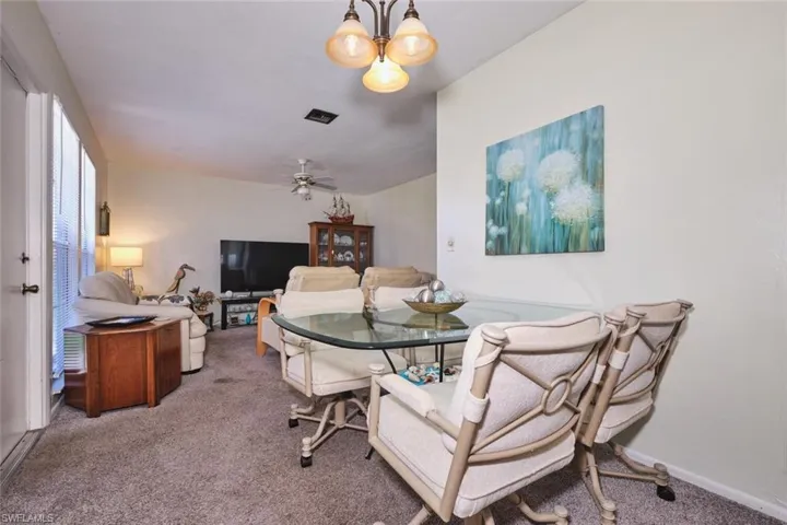 Dining area with carpet flooring, ceiling fan, and baseboards