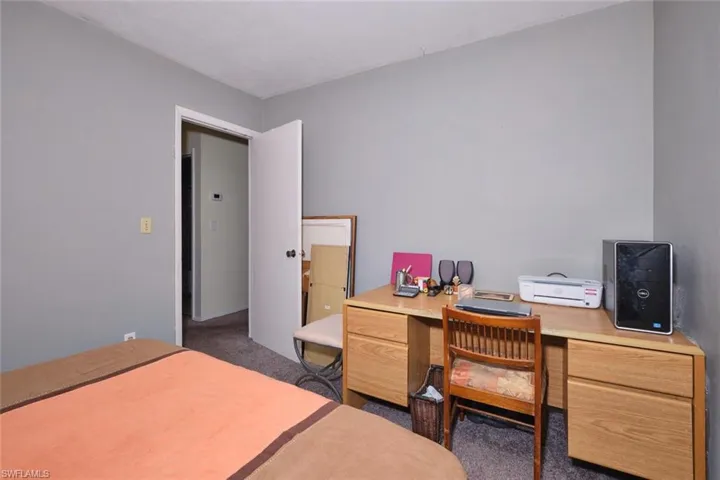 Bedroom featuring carpet flooring and an office area