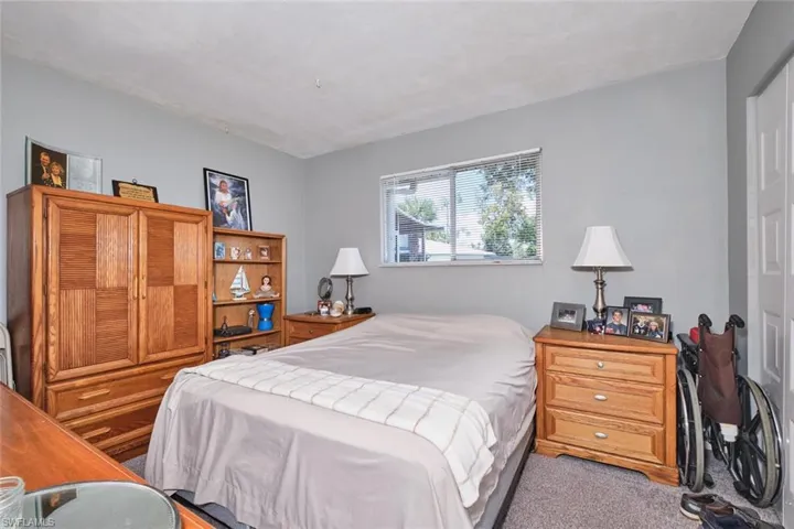 Bedroom featuring light carpet