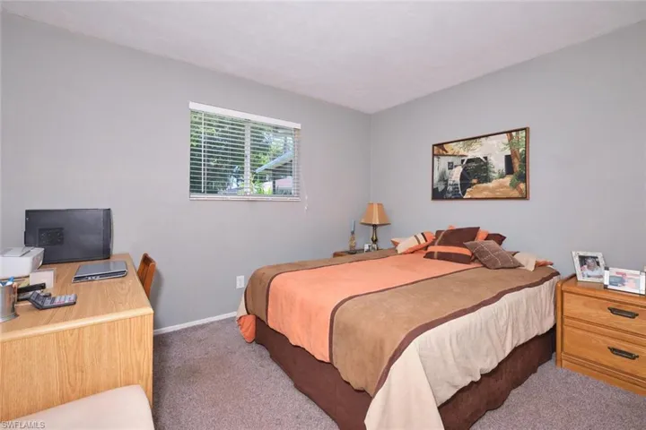 Carpeted bedroom featuring baseboards