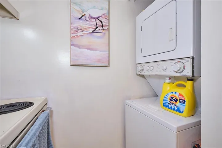 Laundry area with stacked washing machine and dryer