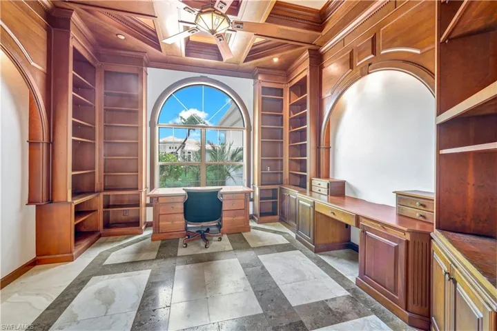 The office space is breathtaking with the built in wood cabinetry, coffered ceiling and custom tile to mimich the coffered ceiling.