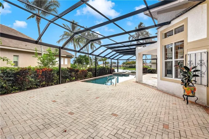 View of pool with a lanai and a patio area, lake view.