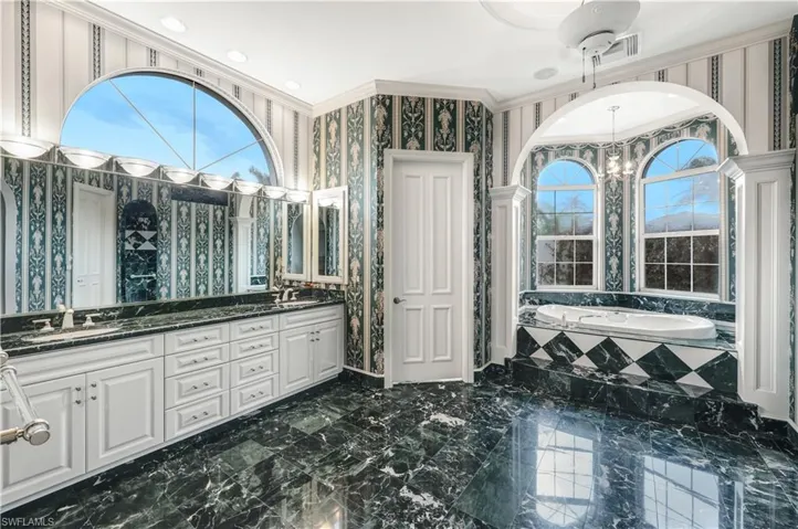 Master Ensuite bath offers marble floors and wet walls, dual comfort height vanities, soaking zen tub, private water closet with toilet and bidet. walk in shower.