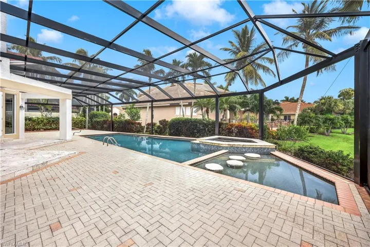 View of pool featuring a patio, an in ground hot tub, and glass enclosure