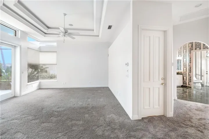 Master suite has double tray lighted ceiling, access to the lanai and pool.