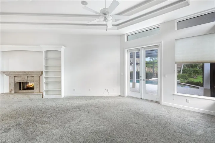 Your master suite has a fireplace, built ins, access to the lanai and pool.  Double tray lighted ceilings.