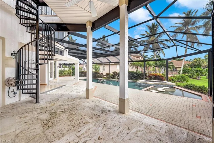 View of swimming pool featuring an in ground hot tub, a patio, and a lanai