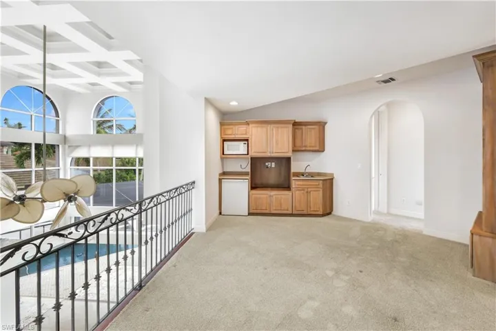 Located on the 2nd level you will find a morning kitchen with microwave, refrigerator, sink.  This overlooks the main living area.