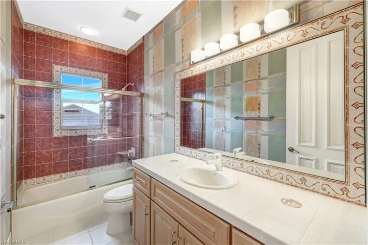 2nd full bathroom with bath / shower combo with glass door.