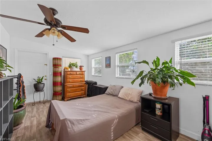 Room featuring ceiling fan, light hardwood / wood-style flooring, and vaulted ceiling