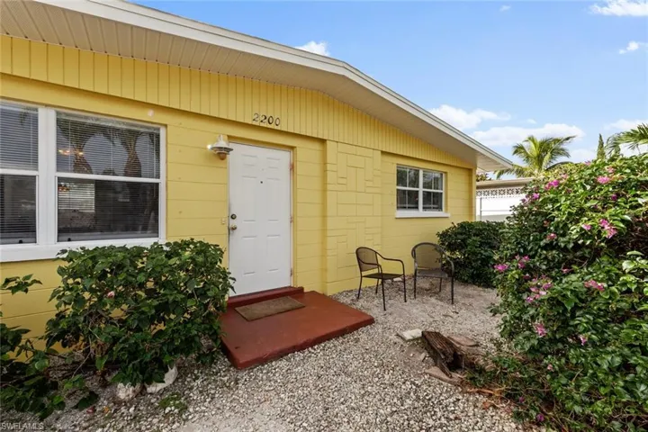 View of exterior entry with a patio area
