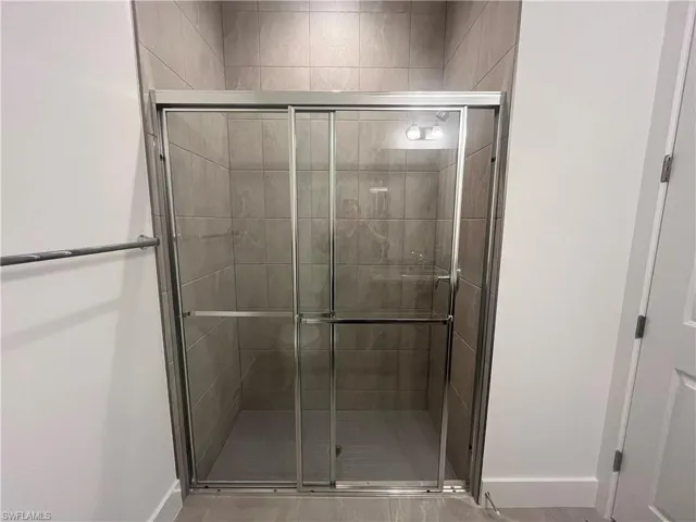Full-length guest shower with gorgeous shower floor and wall tile