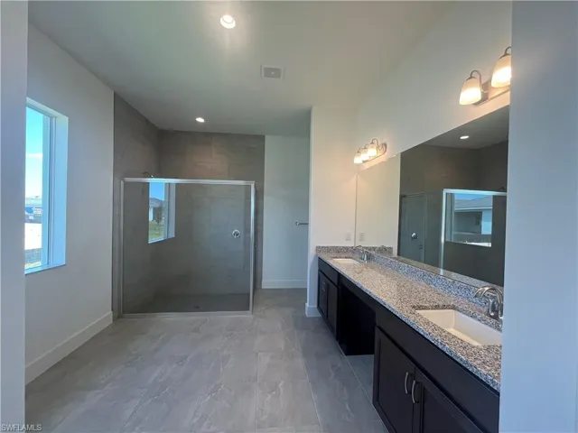 Primary bathroom with luxe, walk-in shower and dual-sinks