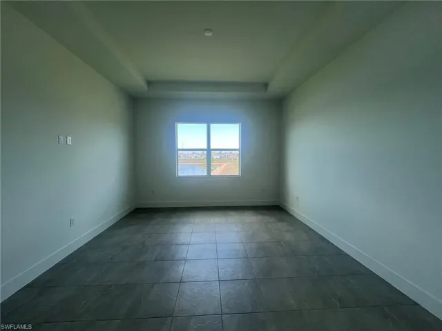 Primary bedroom suite with tray ceiling and gorgeous water view