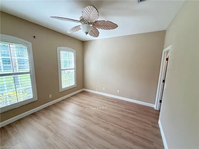 Spare room featuring light wood-style flooring and ceiling fan