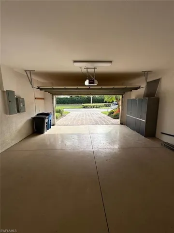 Garage with electric panel and a textured wall