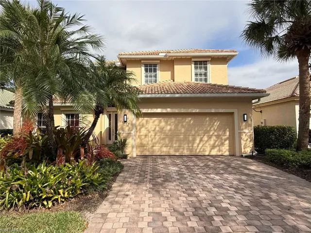 Mediterranean / spanish house featuring decorative driveway, stucco siding, and a tile roof