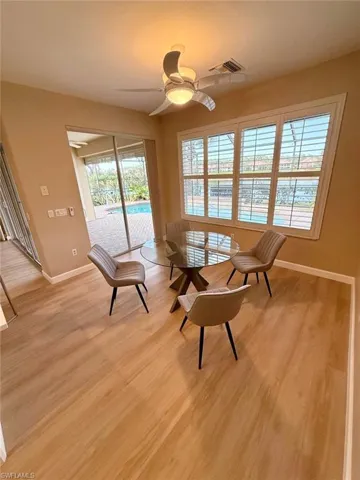 Living area featuring ceiling fan and light wood-style floors
