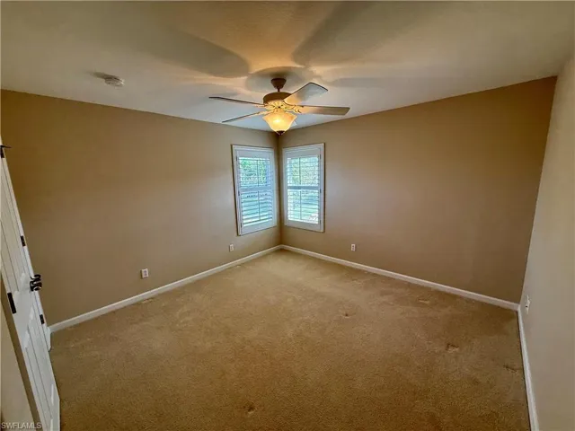 Unfurnished room with carpet floors and ceiling fan