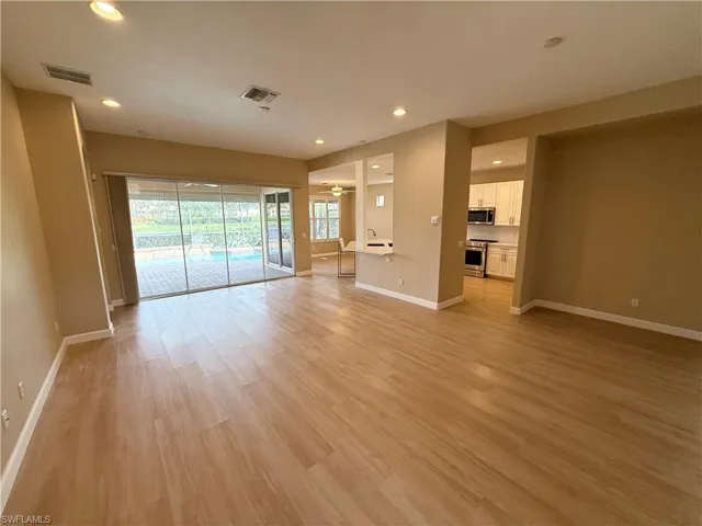 Empty room with recessed lighting and light wood-style floors