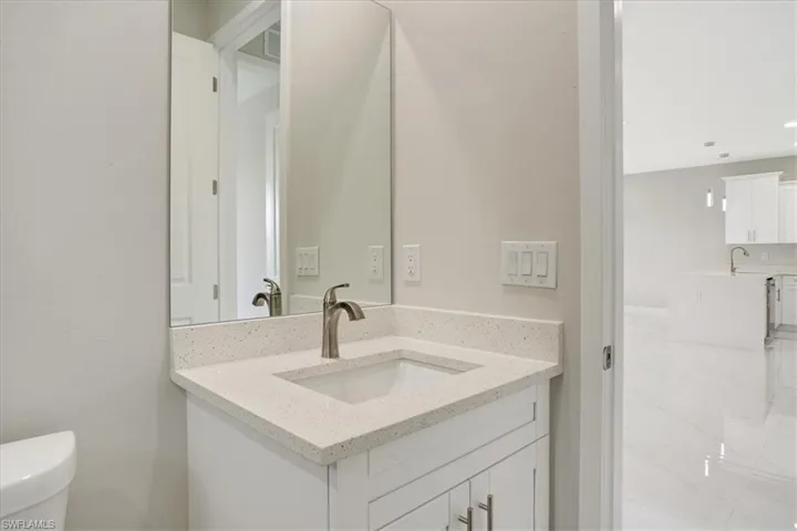 Bathroom featuring vanity and toilet